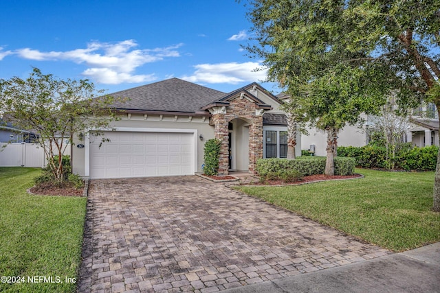 view of front of house featuring a front yard and a garage