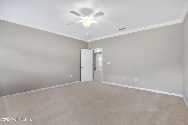 carpeted empty room featuring ceiling fan and ornamental molding