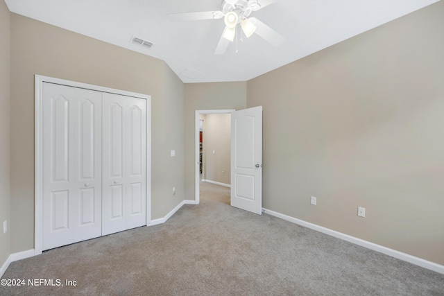 unfurnished bedroom with ceiling fan, light carpet, and a closet