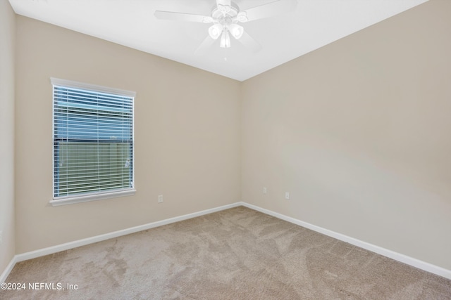 empty room featuring light carpet and ceiling fan