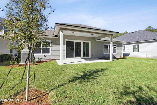 rear view of property featuring a patio area and a lawn