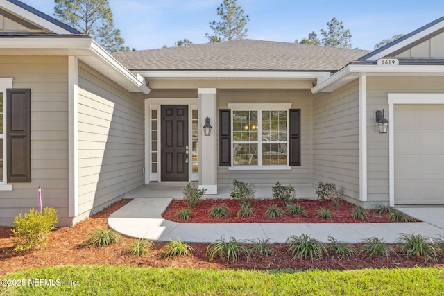 doorway to property with a garage