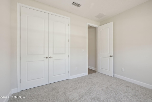 unfurnished bedroom with carpet flooring and a closet