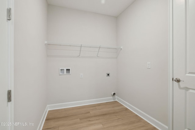 clothes washing area with hookup for a washing machine, light wood-type flooring, and hookup for an electric dryer