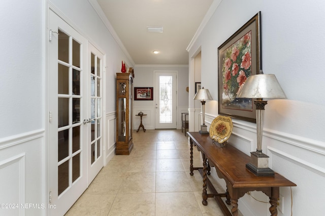 doorway featuring crown molding, french doors, and light tile patterned floors