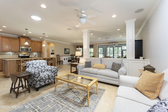 living room with ornate columns, ceiling fan, and crown molding