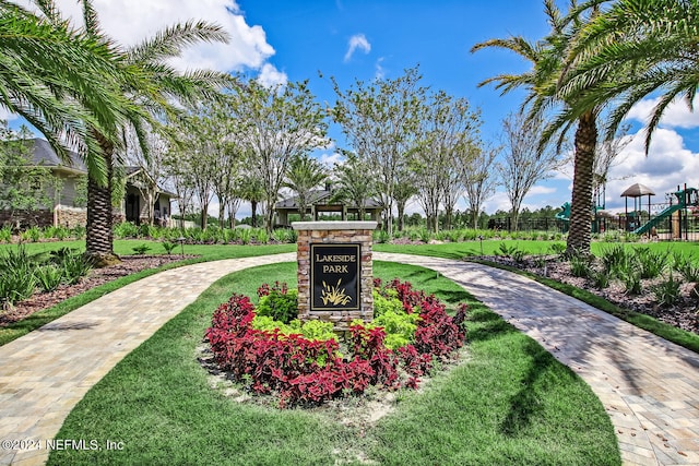 view of property's community featuring a playground and a lawn