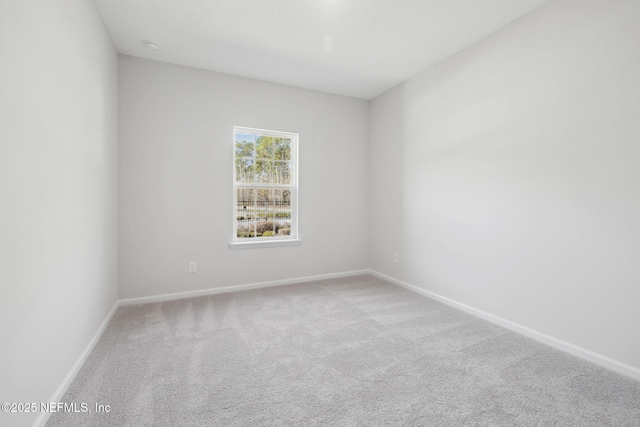 unfurnished room featuring light colored carpet