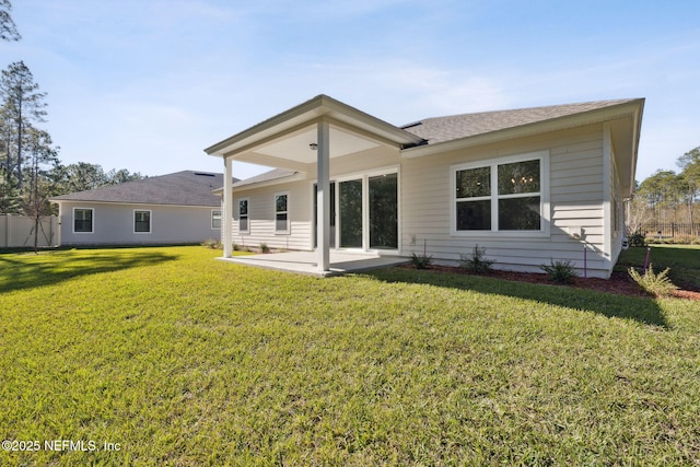 rear view of house featuring a patio area and a lawn