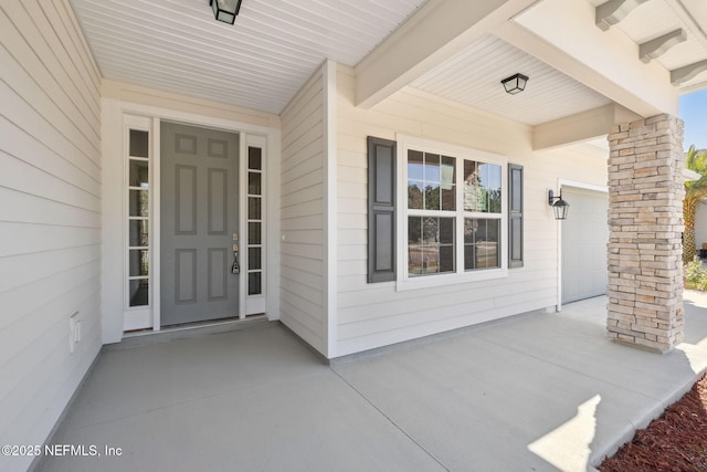 view of exterior entry featuring a garage