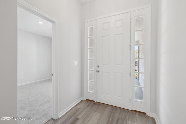 entryway featuring light colored carpet