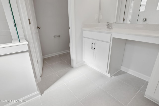 bathroom with tile patterned floors, vanity, toilet, and walk in shower