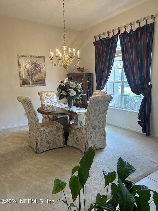 carpeted dining space with a notable chandelier