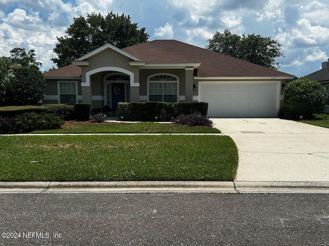 view of front of house with a front lawn and a garage