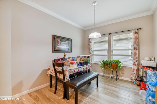 dining space featuring ornamental molding, light hardwood / wood-style flooring, and plenty of natural light