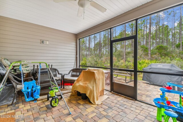 sunroom / solarium featuring ceiling fan