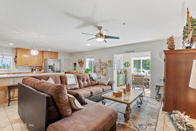 tiled living room featuring a textured ceiling and ceiling fan