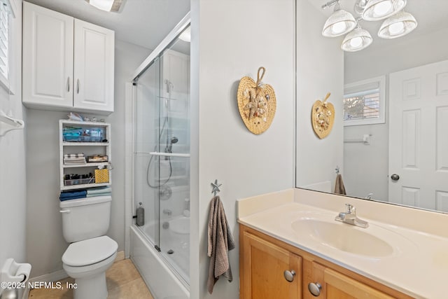 full bathroom with enclosed tub / shower combo, vanity, tile patterned floors, and toilet