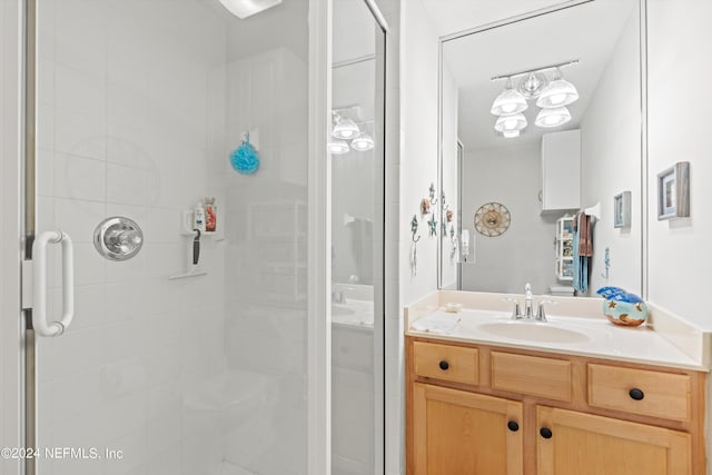 bathroom featuring vanity and a shower with shower door