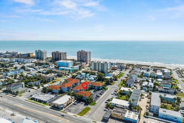 birds eye view of property with a view of the beach and a water view