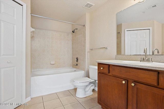 full bathroom featuring vanity, tile patterned flooring, tiled shower / bath combo, and toilet