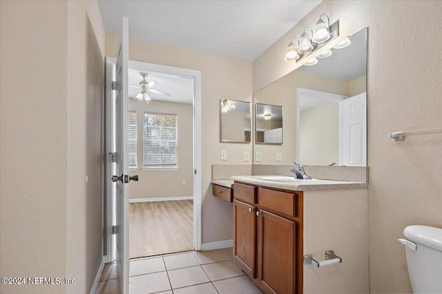 bathroom featuring vanity, tile patterned floors, ceiling fan, and toilet