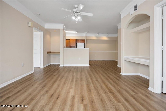 unfurnished living room with track lighting, ornamental molding, light wood-type flooring, and ceiling fan