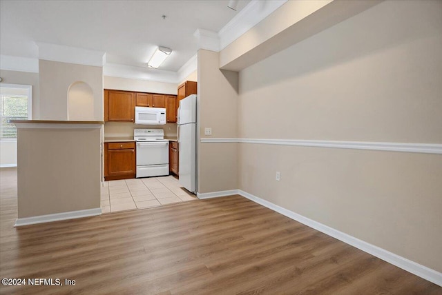 kitchen with white appliances and light tile patterned floors