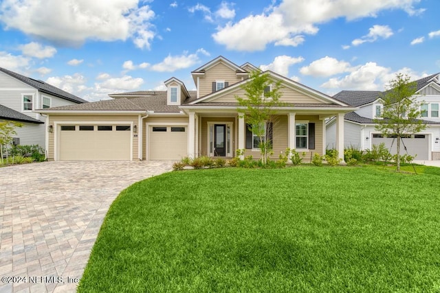 view of front of house with a garage and a front yard