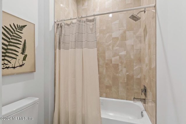 bathroom featuring toilet and shower / bath combination with curtain