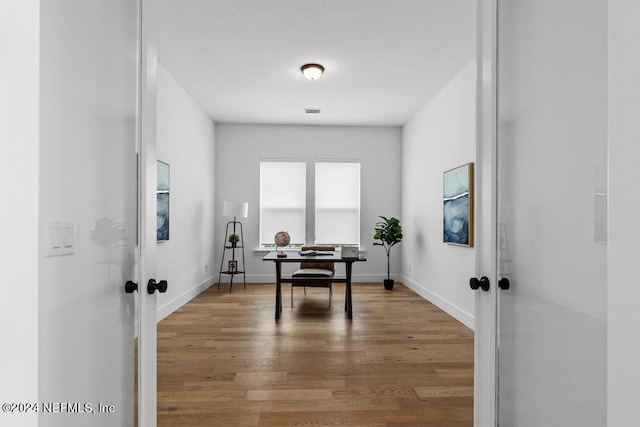 office space featuring hardwood / wood-style flooring and french doors