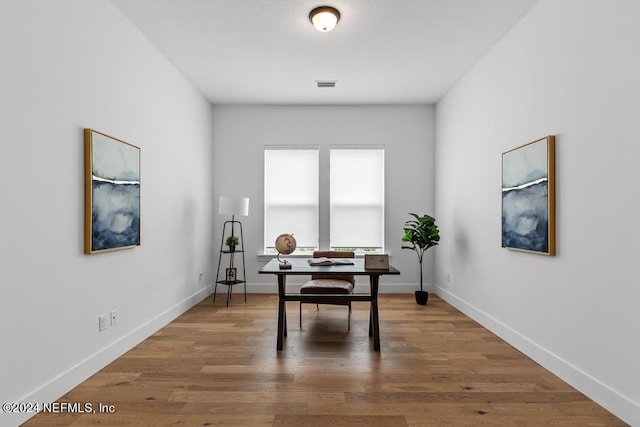 home office with wood-type flooring