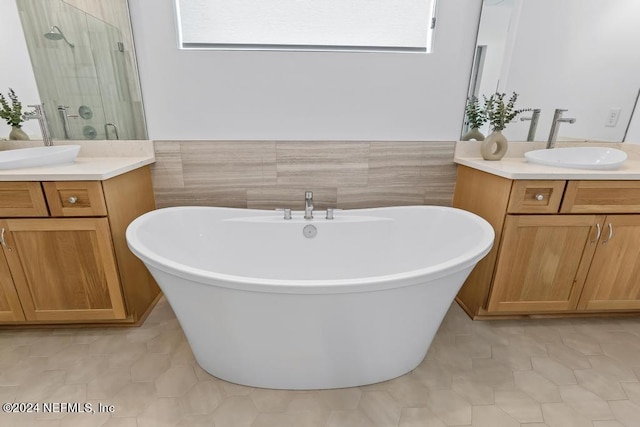 bathroom with tile patterned flooring, double vanity, and a wealth of natural light