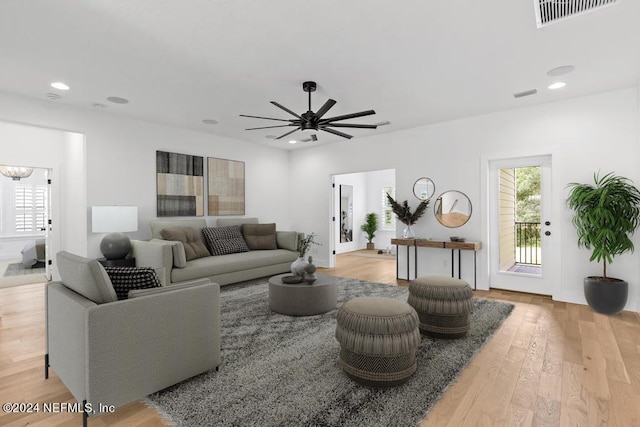 living room featuring light wood-type flooring and ceiling fan