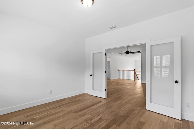 spare room with ceiling fan and hardwood / wood-style flooring