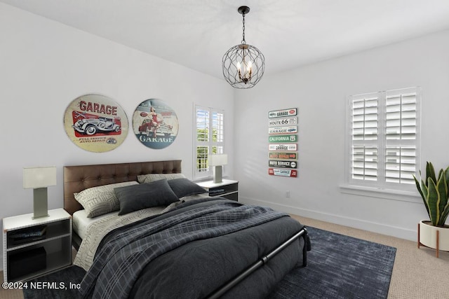 carpeted bedroom featuring a chandelier