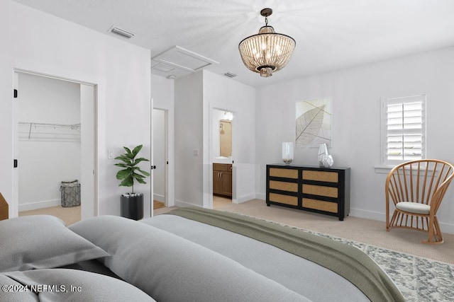 bedroom with a spacious closet, connected bathroom, light colored carpet, and a chandelier