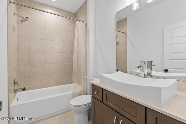 full bathroom with shower / tub combo with curtain, vanity, tile patterned flooring, and toilet