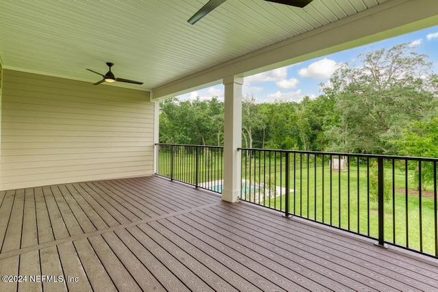 deck with a yard and ceiling fan