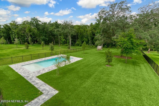 view of swimming pool with a yard