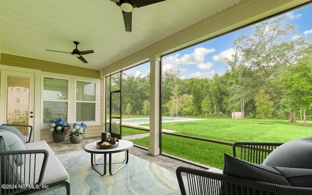 sunroom / solarium featuring ceiling fan