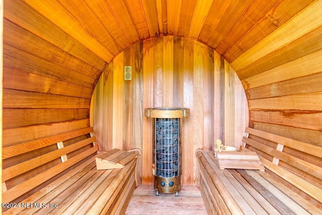 view of sauna / steam room with wood walls, wood-type flooring, and wood ceiling