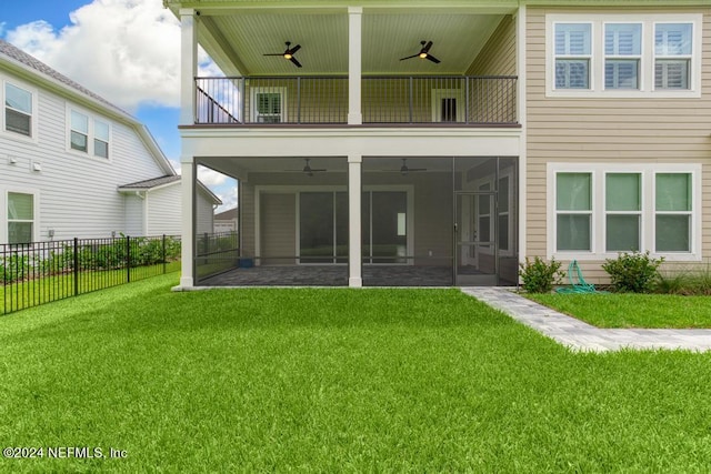 back of house with a balcony, a yard, and ceiling fan