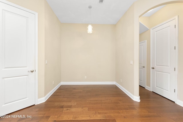 unfurnished dining area with wood-type flooring