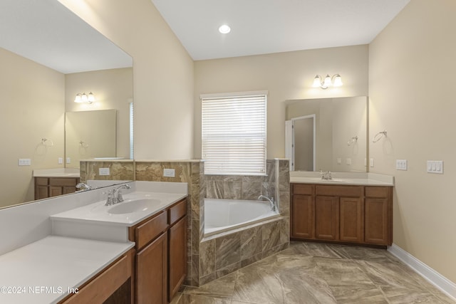 bathroom featuring vanity and a relaxing tiled tub