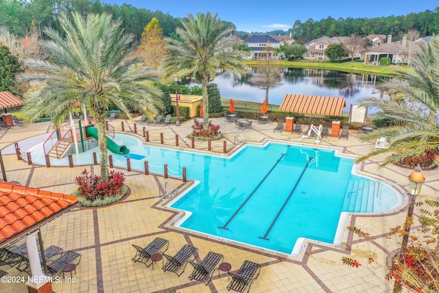 view of pool with a water view and a patio area