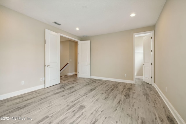 unfurnished bedroom featuring light wood-type flooring