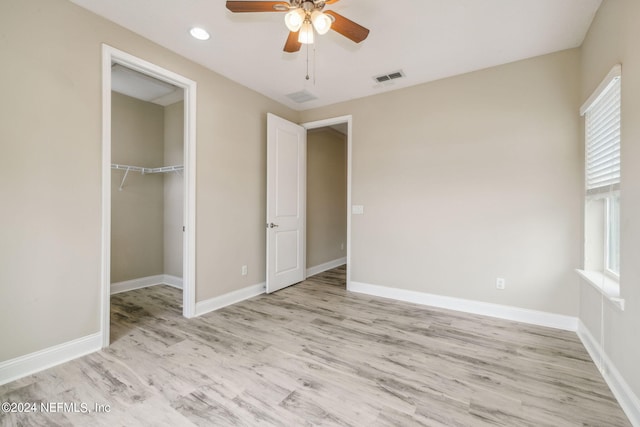 unfurnished bedroom featuring a closet, ceiling fan, and light wood-type flooring