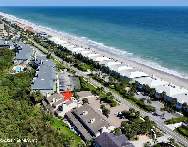 drone / aerial view featuring a water view and a view of the beach