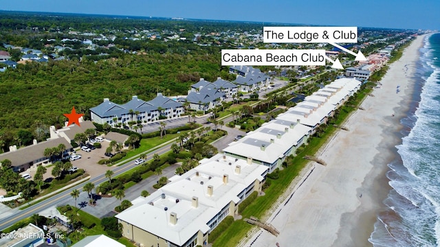 drone / aerial view with a water view and a view of the beach